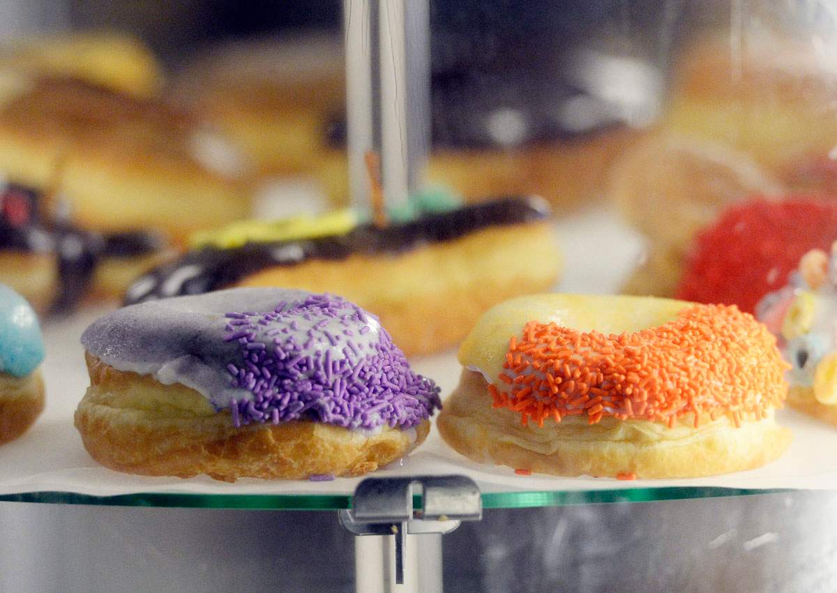 In this Jan. 15, 2014 photo, the Grape Ape and Orangatang Ring doughnuts at Voodoo Doughnut are displayed at the shop in Denver.