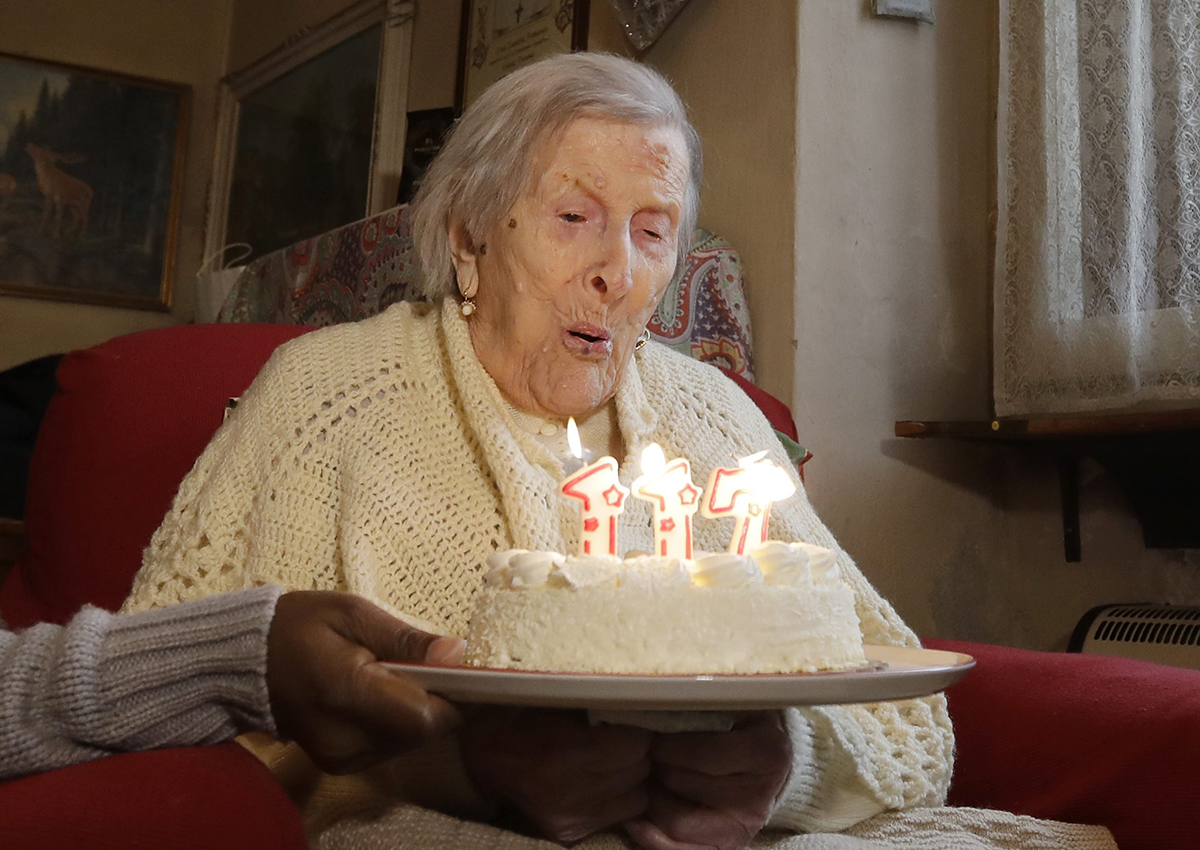 In this Tuesday, Nov. 29, 2016 file photo, Emma Morano, 117 years old, blows candles on the day of her birthday in Verbania, Italy.