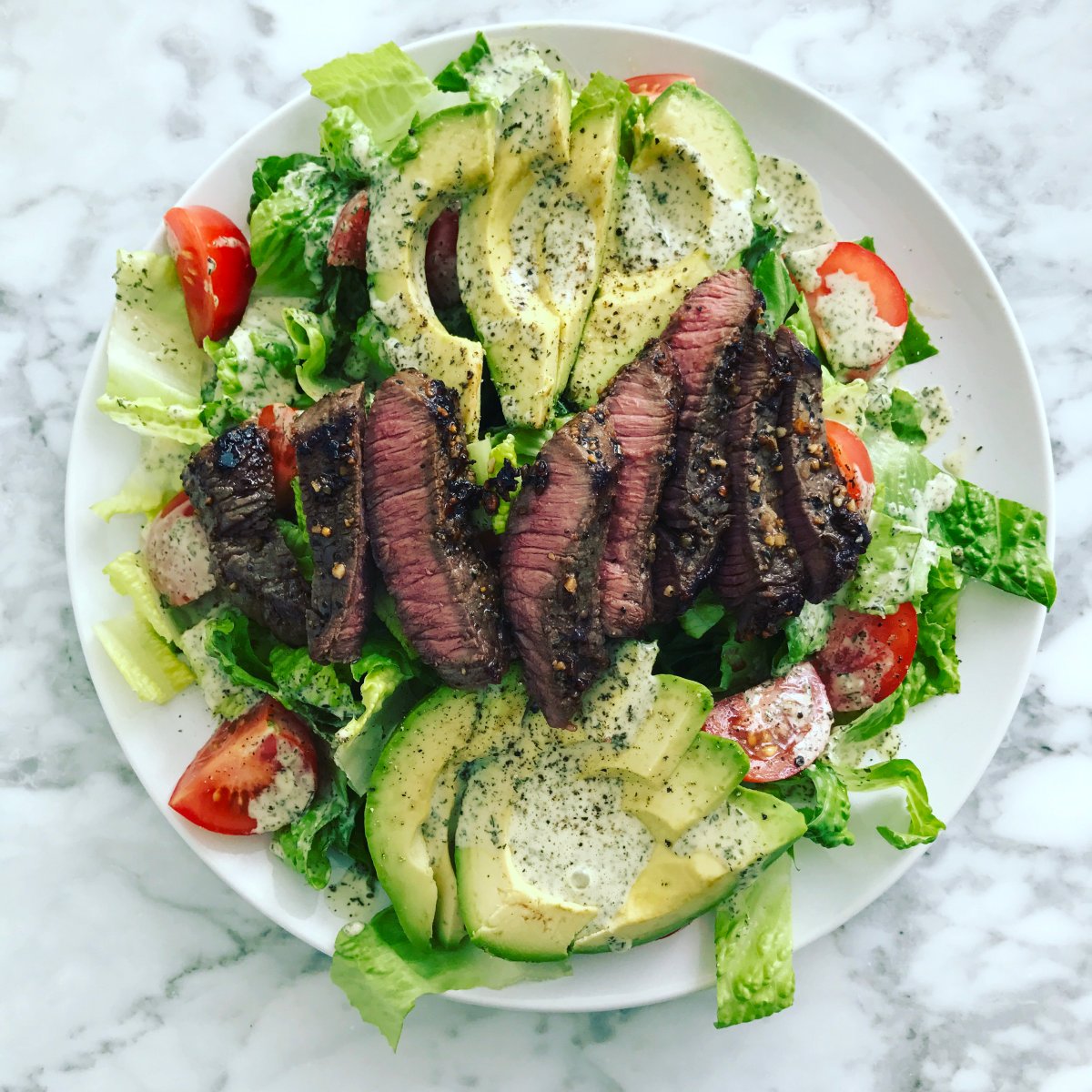 A bed of romaine lettuce with tomatoes, avocado and seared steak: one of Erin Stewart's clean meals. 
