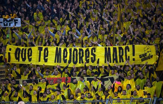 Dortmund fans hold a poster \’Get well, Marc!\’ during the Champions League quarterfinal first leg soccer match between Borussia Dortmund and AS Monaco in Dortmund, Germany, Wednesday, April 12, 2017.