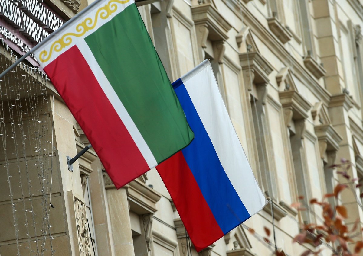 Chechen and Russian flags hung outside a building.
