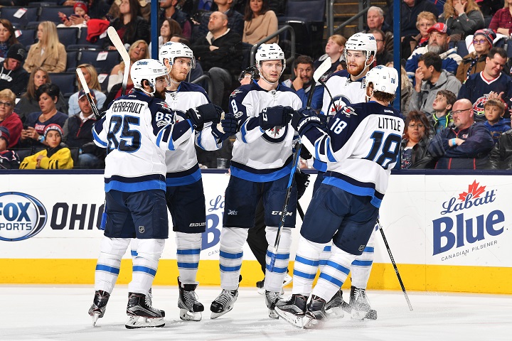 Jacob Trouba of the Winnipeg Jets celebrates his first period goal with his teammates during a game against the Columbus Blue Jackets on April 6, 2017.