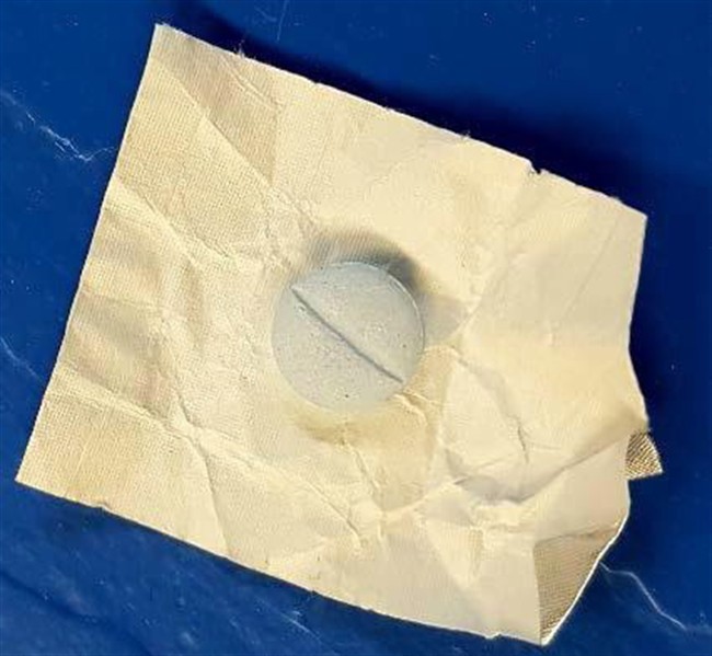 Health Canada has confirmed pills, one of which is shown in an RCMP handout photo, seized on the Esgenoopetitj First Nation in New Brunswick contained fentanyl.