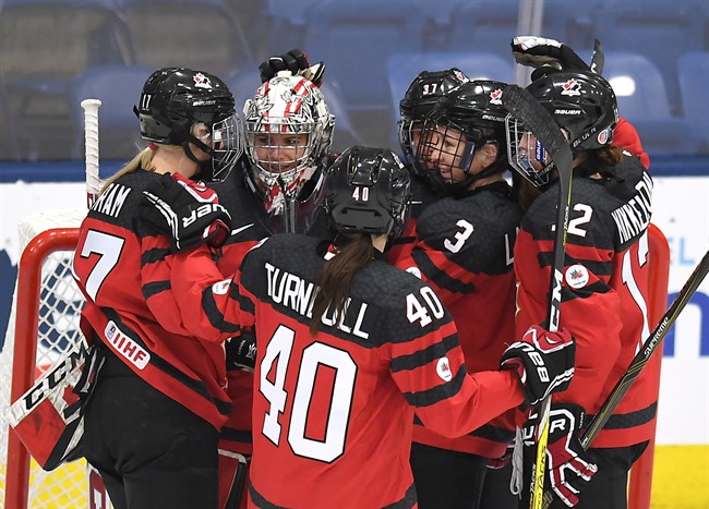 Canada's goaltender Shannon Szabados (1) is congratulated by teammates after they defeated Russia in IIHF Ice Hockey Women's World Championship preliminary round action in Plymouth, Mich., on Monday, April 3, 2017.