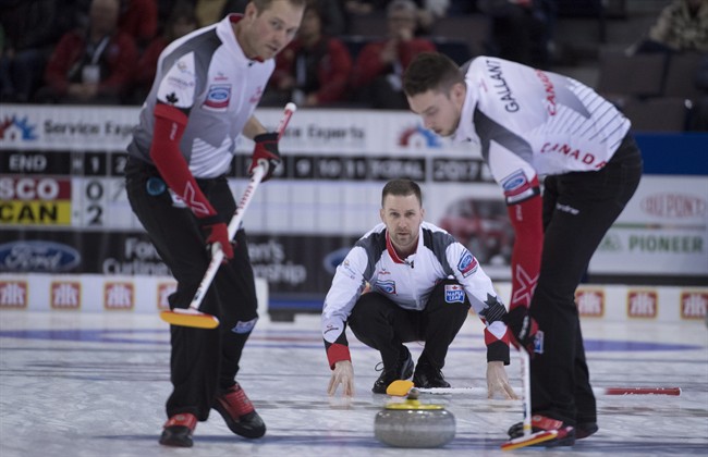 Team Canada skip Brad Gushue makes a shot as lead Geoff Walker, left, and second Brett Gallant look on during the 7th draw against Scotland at the Men's World Curling Championships in Edmonton, Monday, April 3, 2017. 