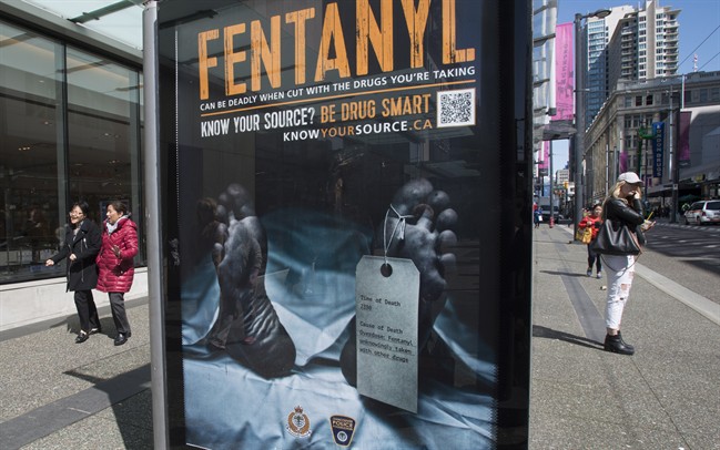 An anti-fentanyl advertisment is seen on a sidewalk in downtown Vancouver, Tuesday, April, 11, 2017. A tag hanging from a dead man's left toe says the cause of death was an overdose of fentanyl, "unknowingly taken with other drugs." The cadaver draped in a white sheet is displayed in transit ads funded by the Vancouver Police Foundation and represents 922 people who died in British Columbia from drug overdoses last year alone. 
