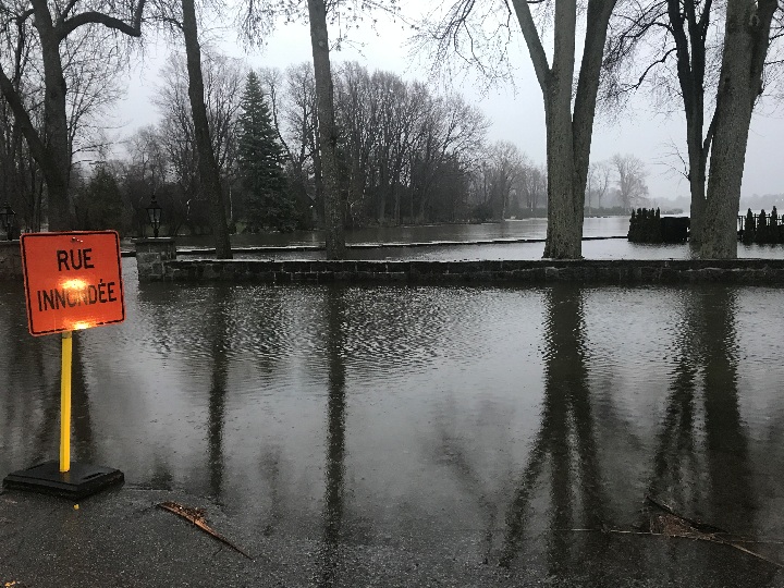 In this photo, a property in Laval-sur-le-Lac is flooded and a sign warns drivers that the street is also flooded.
Friday, April 21, 2017.