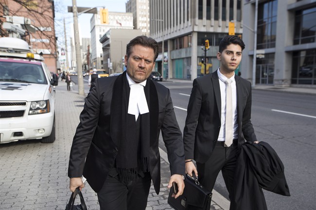 Amedeo DiCarlo, the lawyer for Karim Baratov, left, arrives at the courthouse in Hamilton, Ont., on Tuesday, April 11, 2017. 