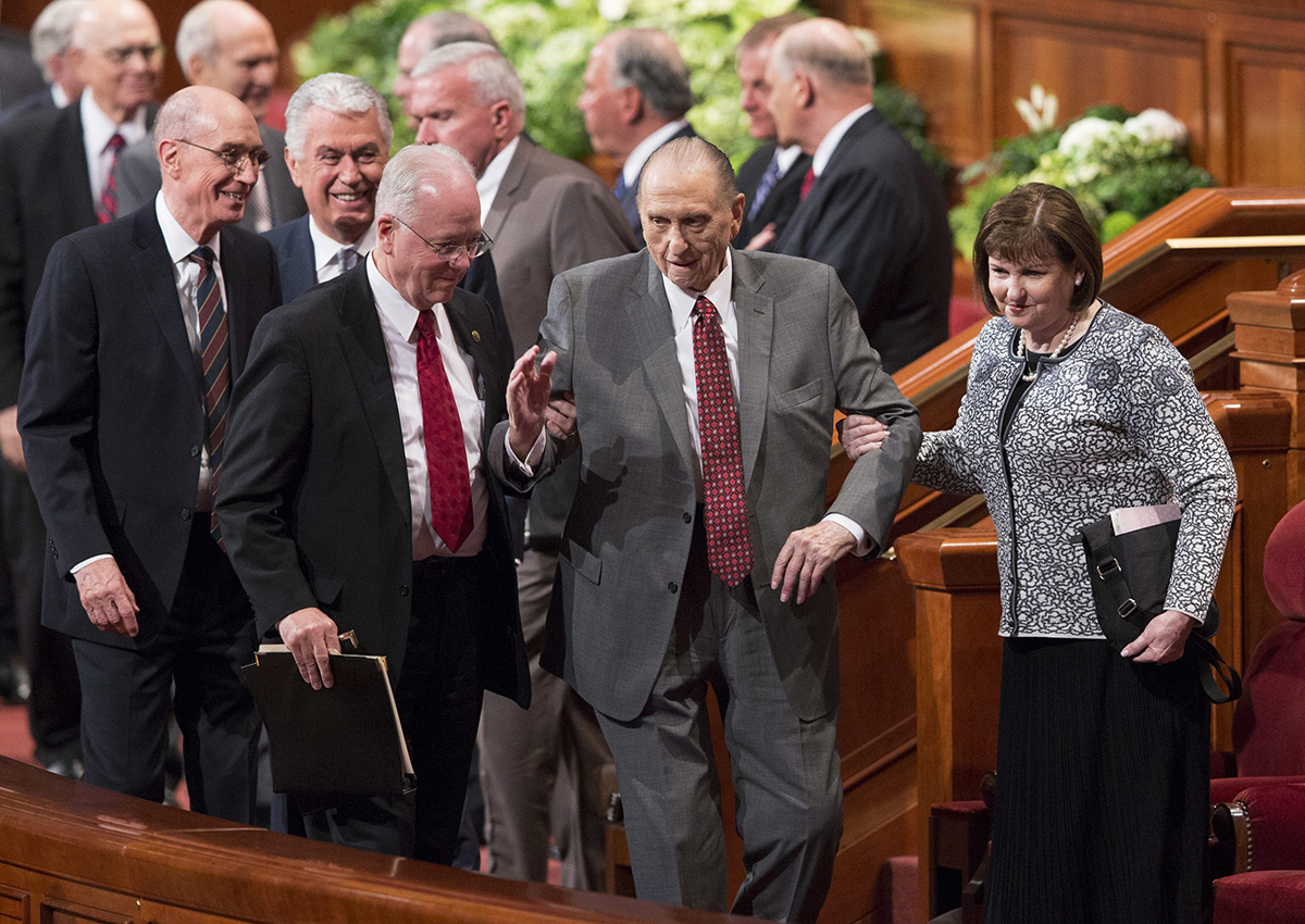 President Thomas S. Monson, center, of The Church of Jesus Christ of Latter-day Saints, walks with his daughter, Ann Dibb, right, as he leaves the morning session of the two-day Mormon church conference Saturday, April 1, 2017, in Salt Lake City. 