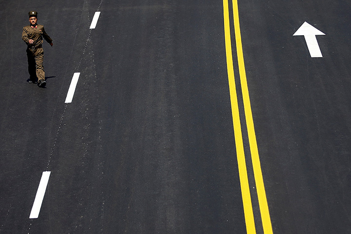 A North Korean soldier walks on the road in the newly constructed residential complex after its opening ceremony in Pyongyang, April 13, 2017.