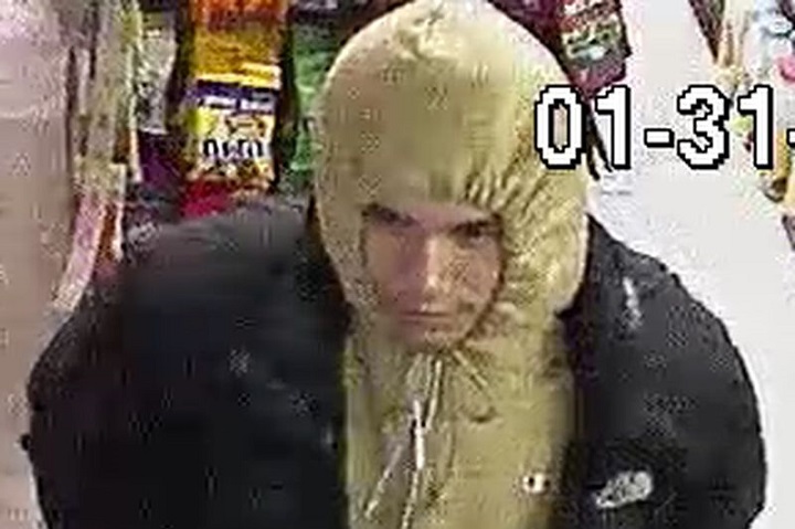 Security camera image of a suspect wanted in three retail robberies in downtown Toronto.