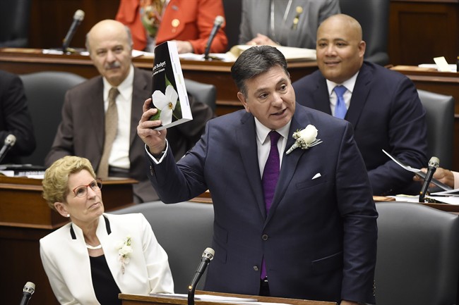 Ontario Finance Minister Charles Sousa, right, delivers the 2017 Ontario budget next to Premier Kathleen Wynne at Queen's Park in Toronto on Thursday, April 27, 2017.