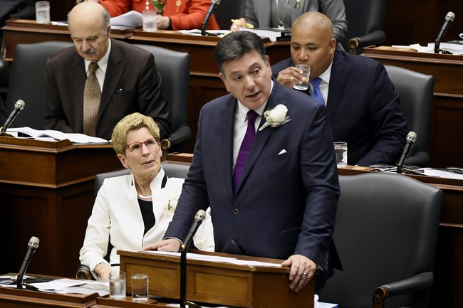 Premier Kathleen Wynne, left, looks on as Ontario Finance Minister Charles Sousa delivers the 2017 Ontario budget at Queen's Park in Toronto on Thursday, April 27, 2017. 
