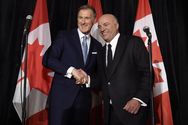 Conservative Party leadership candidate Maxime Bernier (left) shakes hands with Kevin O'Leary at a news conference in Toronto, Wednesday, April 26, 2017, after it was announced that O'Leary had quit the leadership race and thrown his support behind Bernier. 
