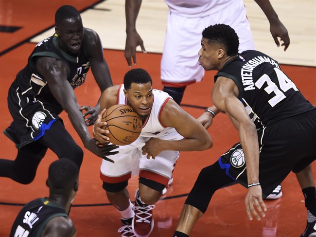 Toronto Raptors guard Kyle Lowry (7) protects the ball from Milwaukee Bucks forward Giannis Antetokounmpo (34) and Bucks forward Thon Maker (7) during second half NBA playoff basketball action, in Toronto on Saturday, April 15, 2017.