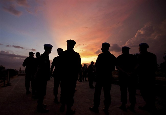 FILE – This Monday, July 11, 2011, file photo shows silhouettes of UN peacekeepers from Brazil at the airport in Port-au-Prince, Haiti. (AP Photo/Eduardo Verdugo)