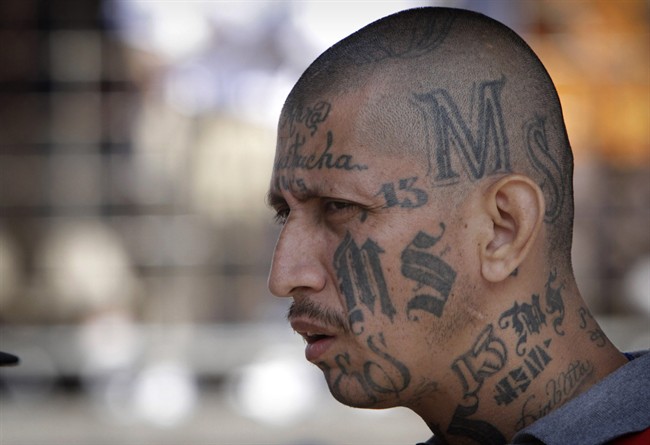 In this March 26, 2012 file photo a gang member of MS-13 attends mass at a prison in Ciudad Barrios, El Salvador