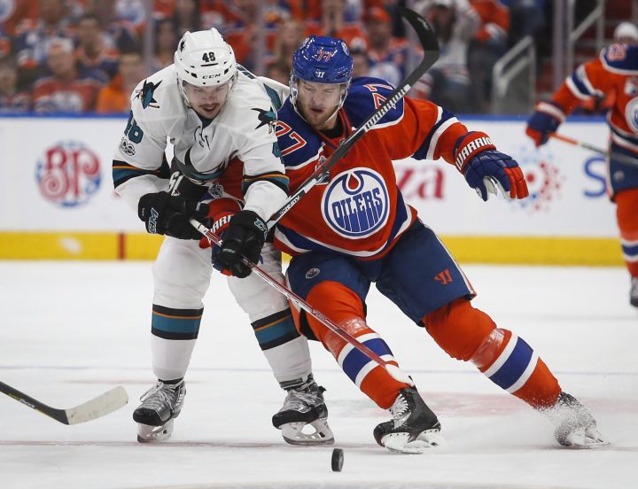 San Jose Sharks' Tomas Hertl, left, of the Czech Republic, vies with Edmonton Oilers' Oscar Klefbom, of Sweden, for control of the puck during third period NHL hockey round one playoff action in Edmonton, Thursday, April 20, 2017. 