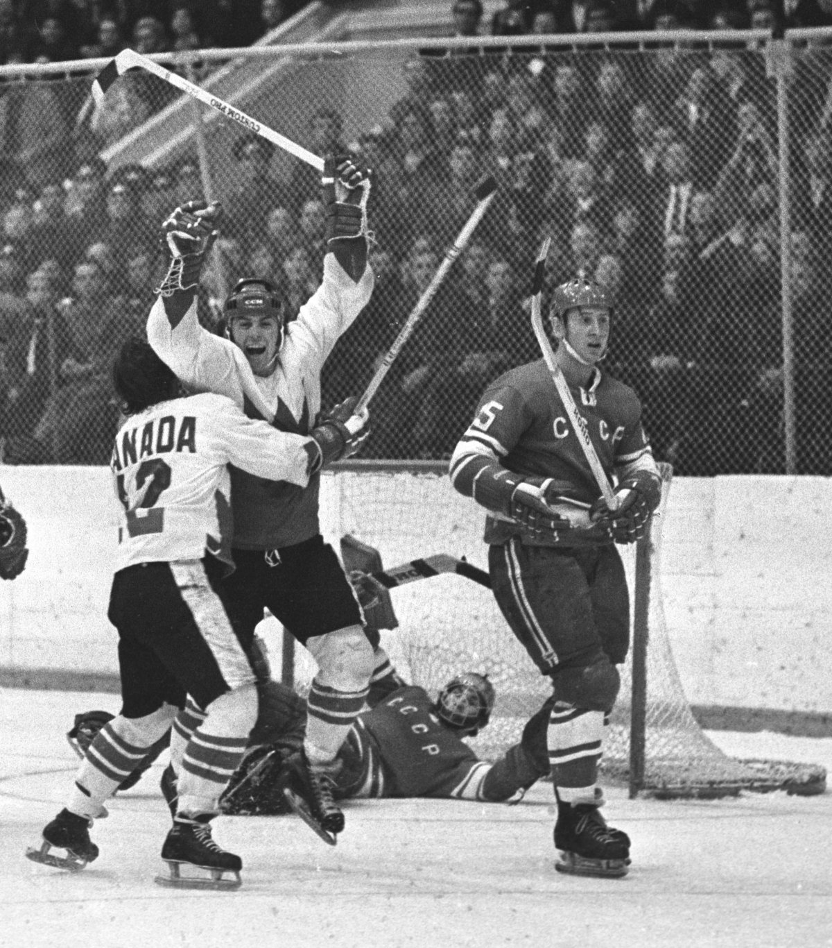 Yvan Cournoyer (12) hugs Paul Henderson after Henderson's goal won the eight-game Summit Series against the Soviet Union, Sept. 28, 1972.
