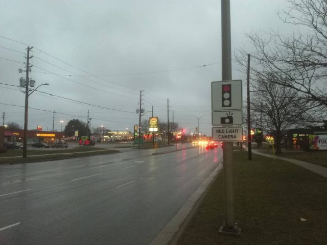 Red light camera sign at the intersection of Highbury Ave and Huron Street in London, Ont.
