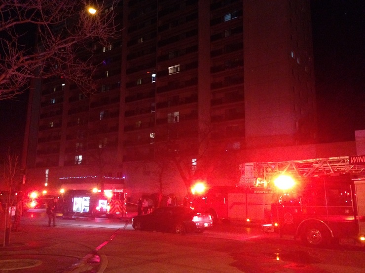 Tenants of the building can be seen gathering out front of their building Tuesday night. 