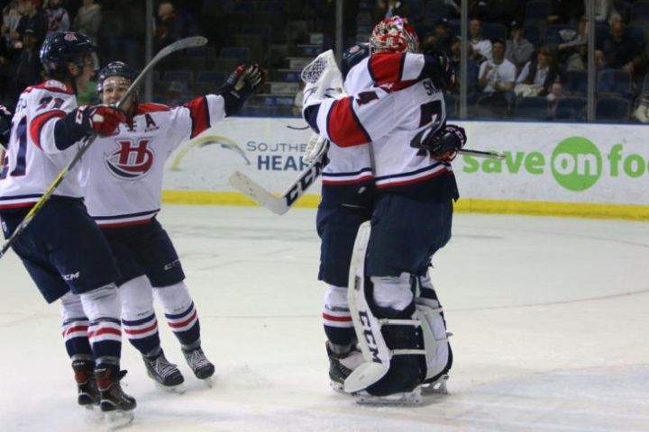 Lethbridge Hurricanes players celebrate after a game five win.