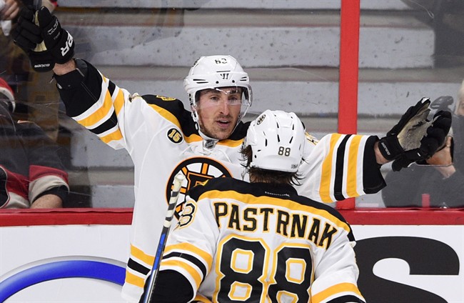Boston Bruins left wing Brad Marchand (63) celebrates his game-winning goal with teammate David Pastrnak during the third period of the first round of Stanley Cup playoff action against the Ottawa Senators, in Ottawa on Wednesday, April 12, 2017.