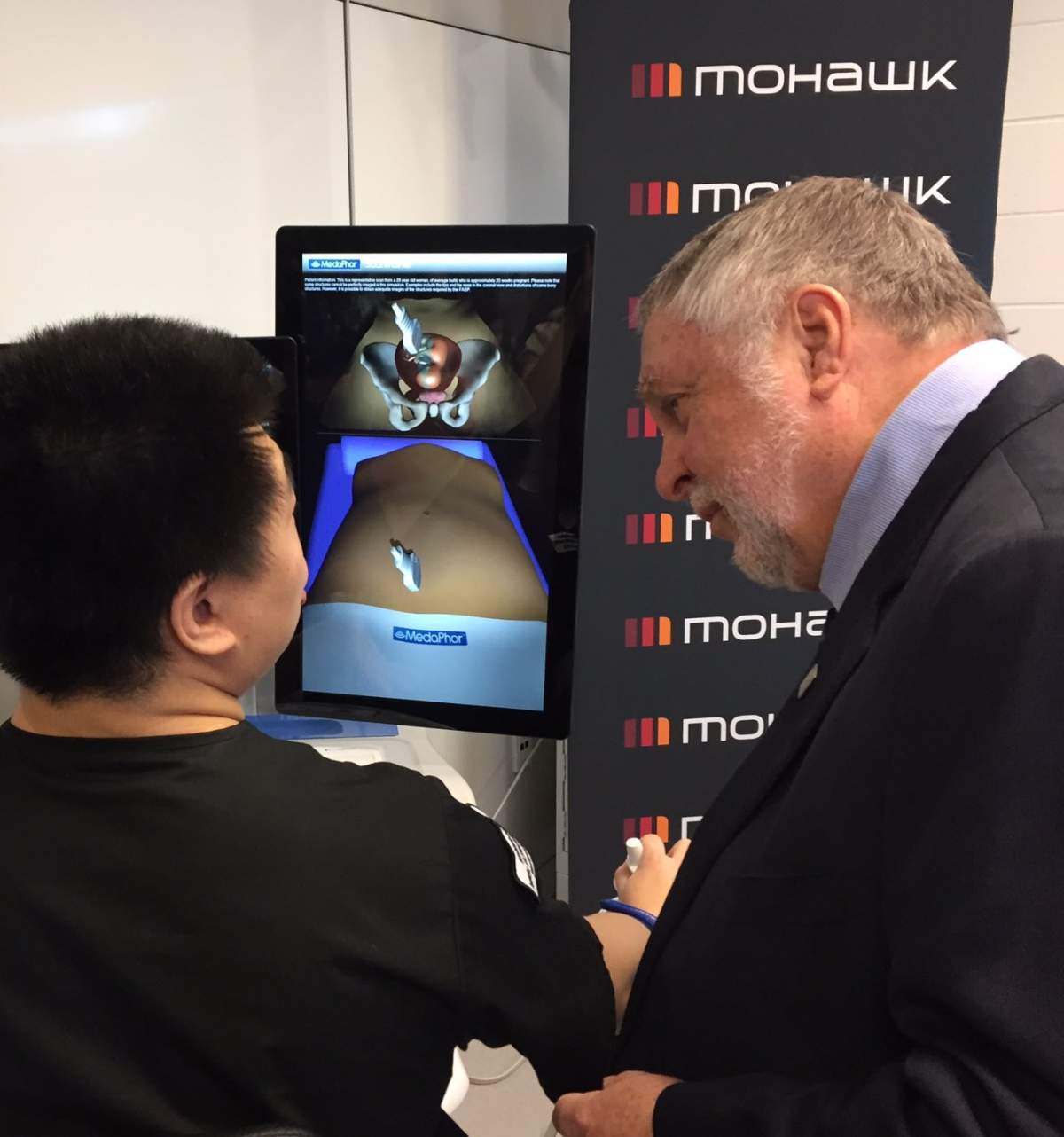 MPP Ted McMeekin speaks with Mohawk College student about 3D imaging technology at the Centre for Health Care simulation.