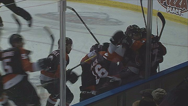 Medicine Hat Tigers players storm the ice after John Dahlstrom scores the overtime winner in game four.