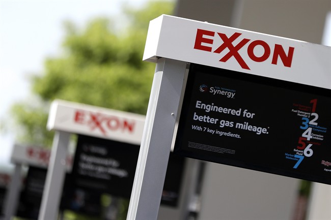 This April 25, 2017, photo, shows Exxon service station signs in Nashville, Tenn. 