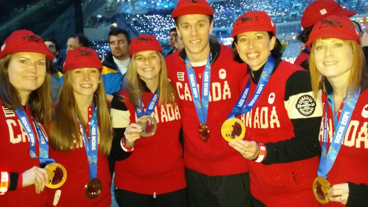 Jill Officer's team poses with Jonathan Toews at the Olympics. 