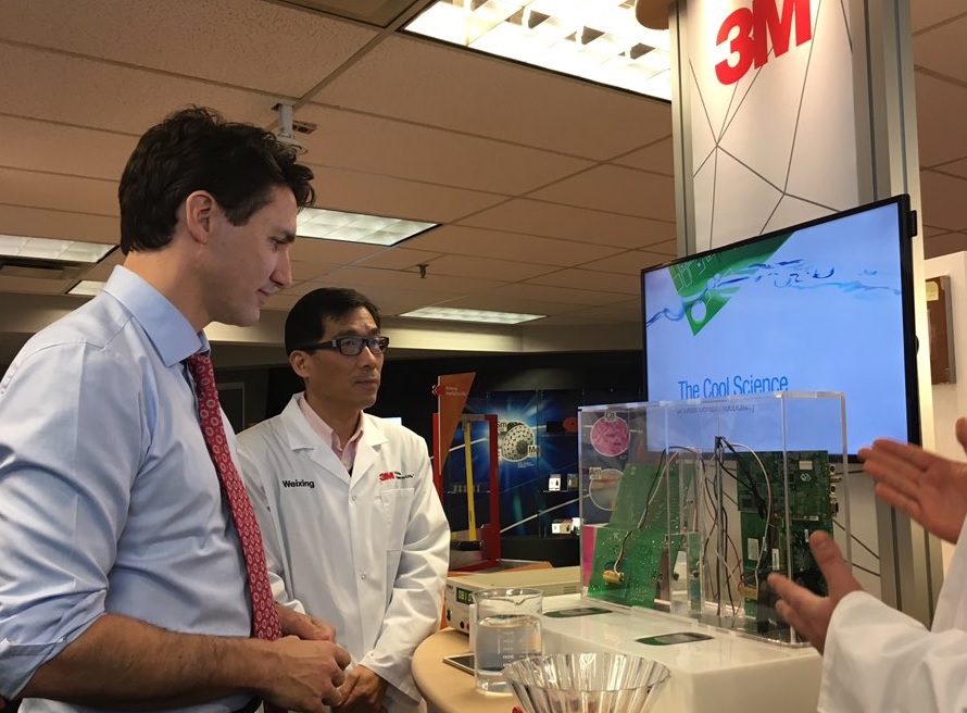 Prime Minister Justin Trudeau takes a look at fluid designed to stop fires.
