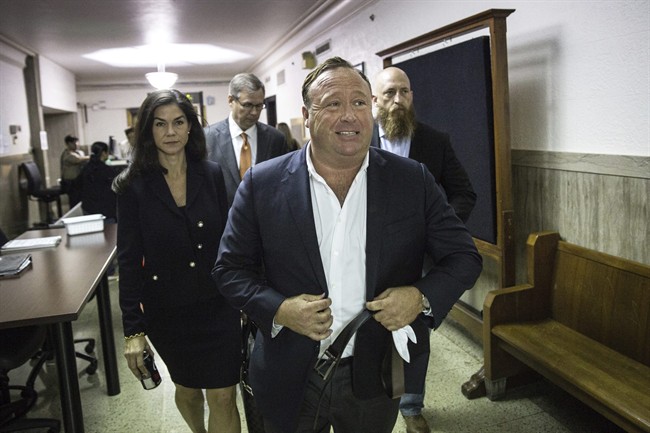 In this Monday, April 17, 2017, photo, "Infowars" host Alex Jones arrives at the Travis County Courthouse in Austin, Texas.