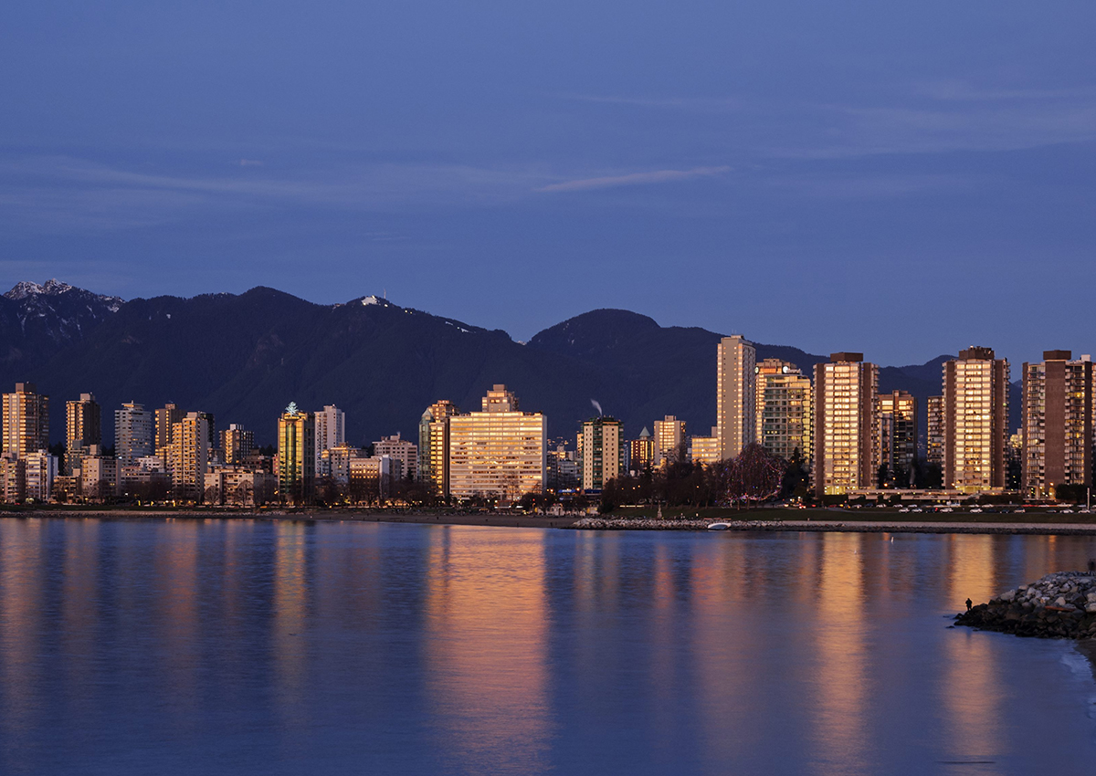 A colourful sunset is reflected in English Bay by the high-rise buildings of Vancouver's West End district, January 5, 2014. 
