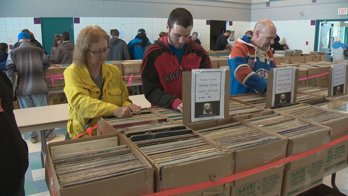 Customers search for vinyl records at the fourth annual Super Mega Records garage sale, Sunday, April 16, 2017. 