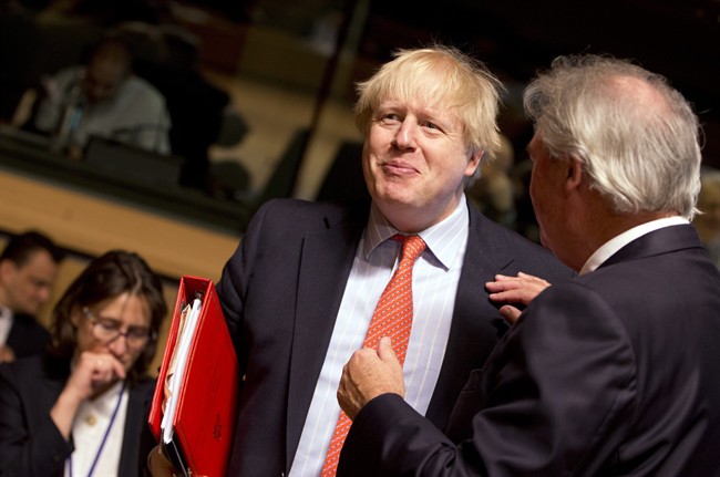 FILE - British Foreign Secretary Boris Johnson, left, speaks with Luxembourg's Foreign Minister Jean Asselborn during a meeting of EU foreign ministers at the EU Council building in Luxembourg on Monday, April, 2017.
