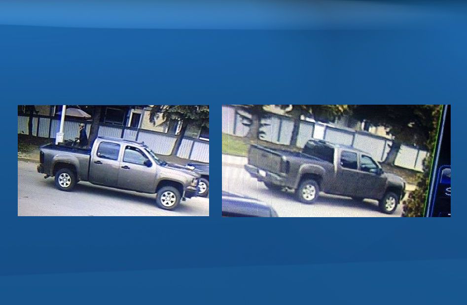 The vehicle is described as a dark grey GMC Sierra or Chevy Silverado with tinted tail light covers and a black front bumper. 