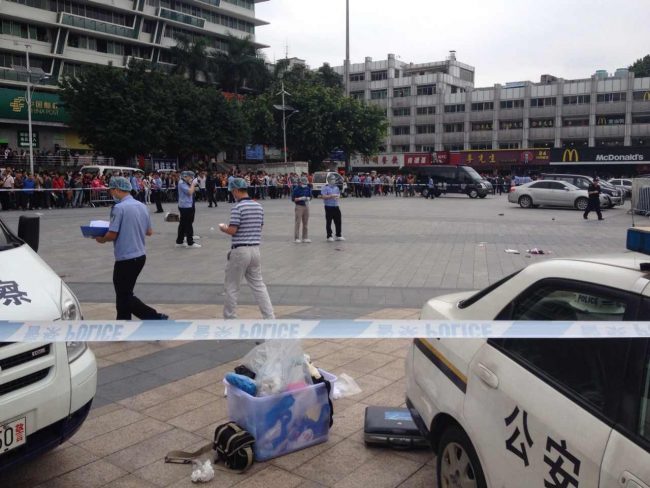 A May 6, 2014 file photo of police inspecting the scene of a knife attack in Guangzhou, China. 