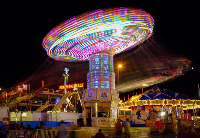 Riders swing by in a blur as they enjoy the midway attractions at the Calgary Stampede in Calgary, Saturday, July 9, 2016. 