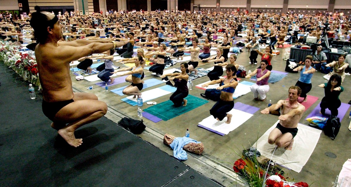 In this Sept. 27, 2003, file photo, Bikram Choudhury, front, founder of the Yoga College of India and creator and producer of Yoga Expo 2003, leads a yoga class at the Expo at the Los Angeles Convention Center. 