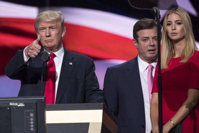 In this July 21, 2016 file photo, then-Trump Campaign manager Paul Manafort stands between the then-Republican presidential candidate Donald Trump and his daughter Ivanka Trump during a walk through at the Republican National Convention in Cleveland. 