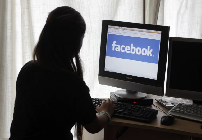 A girl logs onto Facebook in this June 4, 2012 file photo.
