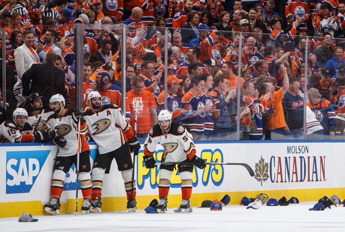 Anaheim Ducks' Andrew Cogliano (7), Ryan Kesler (17) and Nic Kerdiles (58) wait for the hats to be cleaned up after Edmonton Oilers' Leon Draisaitl (29) scored a hat trick during the second period in game six of a second-round NHL hockey Stanley Cup playoff series in Edmonton on Sunday, May 7, 2017. THE CANADIAN PRESS/Jason Franson.