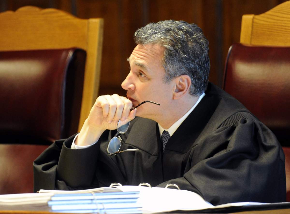 In this June 1, 2016, file photo, New York Court of Appeals Associate Judge Michael J, Garcia, listen to oral arguments on whether criminal defendants should be allowed to use allegations made in civil rights lawsuits against police witnesses to question their credibility during cross-examination at the Court of Appeals in Albany, N.Y.