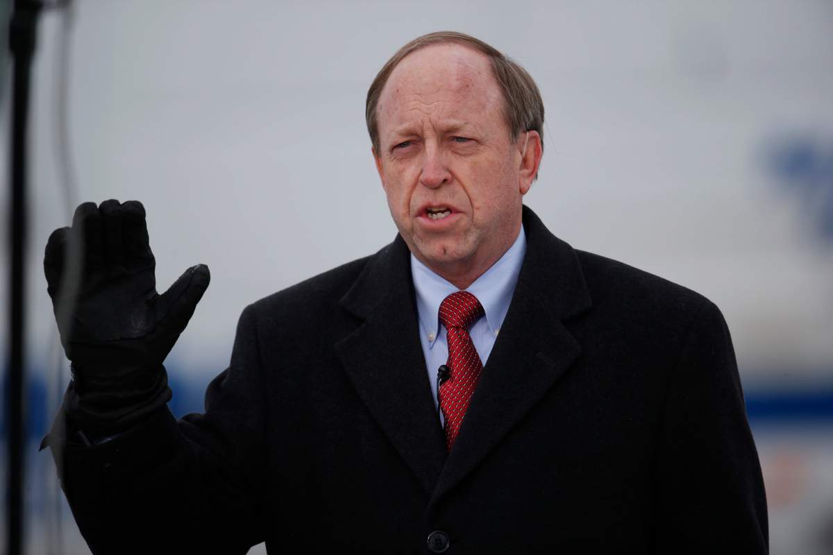 In this Nov. 29, 2015, file photo, Colorado Springs, Colo., Mayor John Suthers talks to a reporter as police investigators gather evidence near the scene of Friday\’s shooting at a Planned Parenthood clinic.