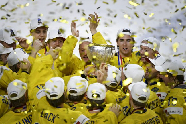 Team Sweden celebrating world championship with the championship trophy after penalty shoot-out at the gold medal match Sweden vs Canada of the 2017 IIHF Ice Hockey World Championships in Cologne, on May 21, 2017.