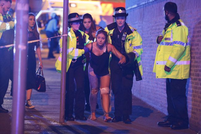 Police and other emergency services are seen near the Manchester Arena after the reported explosion, May 22, 2017.