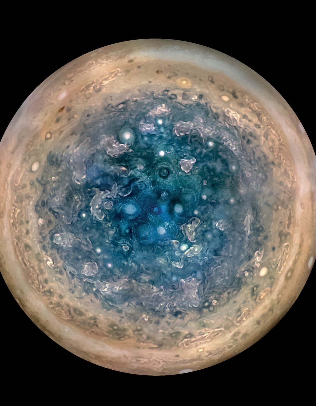 This image made available by NASA on Thursday, May 25, 2017, and made from data captured by the Juno spacecraft shows Jupiter's south pole. The oval features are cyclones, up to 600 miles (1,000 kilometers) in diameter. The cyclones are separate from Jupiter's trademark Great Red Spot, a raging hurricane-like storm south of the equator. The composite, enhanced color image was made from data on three separate orbits. 