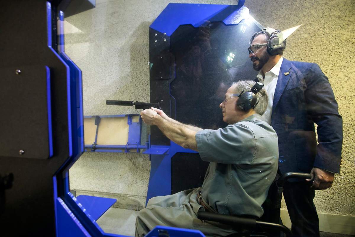 After signing into law Senate Bill 16, legislation lowering the license to carry fee, Texas Gov. Greg Abbott takes target practice at The Range in South Austin under the guidance of Director of Training Jeff Gonzales Friday, May 26, 2017.