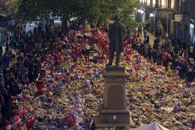 People view tributes to victims in St Ann's Square as they prepare to mark the passing of exactly a week since the Manchester Arena concert blast, in Manchester, England, Monday May 29, 2017. (.